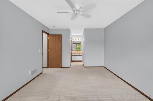 Primary bedroom with direct access to upper-level full bath.
