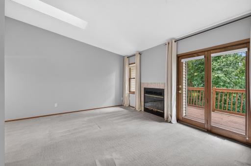 Inviting living room with fireplace and walkout to the deck.