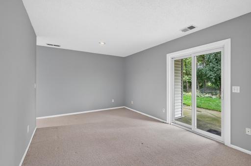 Flexible lower-level space ideal for a family room, office, or potential bedroom.