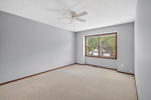 Spacious upper-level primary bedroom with front-facing views.