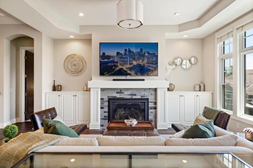 Gas fireplace flanked by custom built-ins.