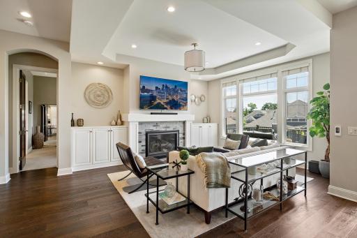 The elegant living room is anchored by a gas fireplace and flows seamlessly into the formal dining area and gourmet chefâs kitchen.
