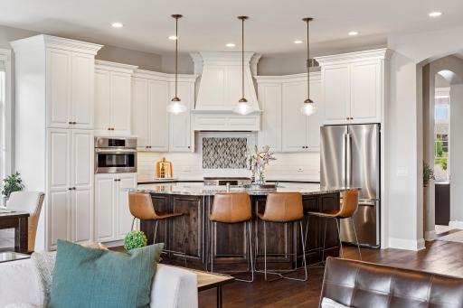 Perfectly appointed kitchen with Bosch appliance suite, oversized center island, and custom cabinetry.