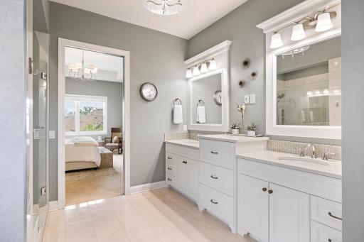 Luxurious primary bathroom featuring a spa-inspired soaking tub + walk-in tile shower.