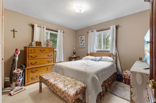 Second upper-level bedroom with dual windows and neutral tones.
