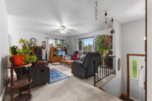 Inside, the upper-level living room offers a comfortable gathering place with plenty of natural light.