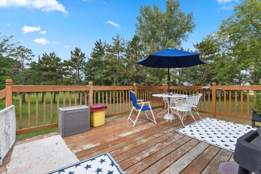 Step outside to a spacious deck overlooking the peaceful 1.45-acre setting.