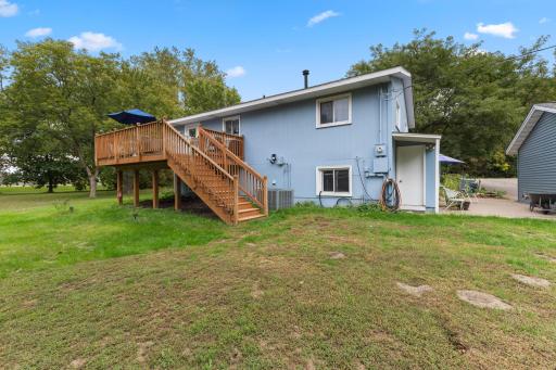 Exterior stairs provide convenient access between the upper-level deck and the yard below.