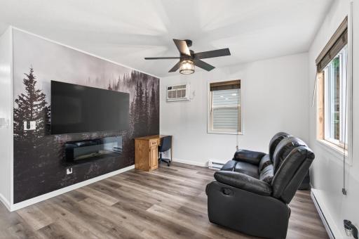 LVT flooring, white trim, and electric fireplace