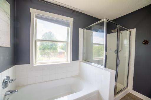 Primary ensuite bath with double vanity and separate tub and shower