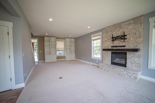 Light and airy living room with gas fireplace and stone surround