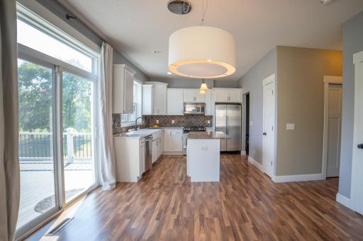 Kitchen with stainless appliances, quartz and granite counters