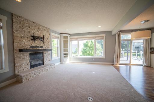 Light and airy living room with gas fireplace and stone surround