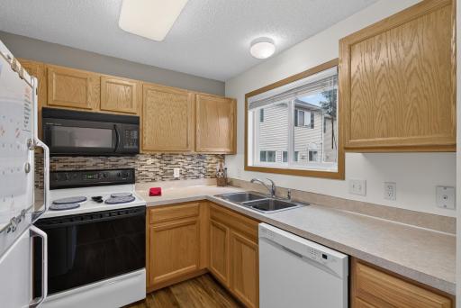Freshly painted kitchen with window over sink overlooing green space