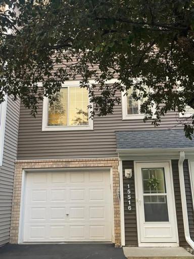 Front elevation has storm door and gutters