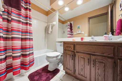 This spacious primary bathroom is adjacent to the primary bedroom.