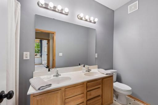 A centrally located full bath serves the upper-level living spaces.