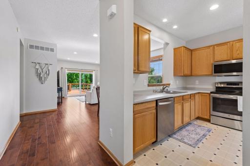 A bright, open layout connects the kitchen, dining area, and living room.