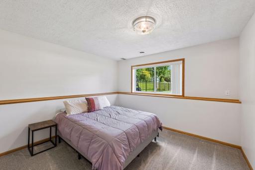 Bright and comfortable lower-level bedroom offering privacy and flexibility.