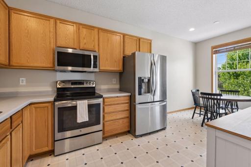 The kitchen is complemented by a light-filled dining nook, perfect for everyday meals, conversation, or a convenient workspace.