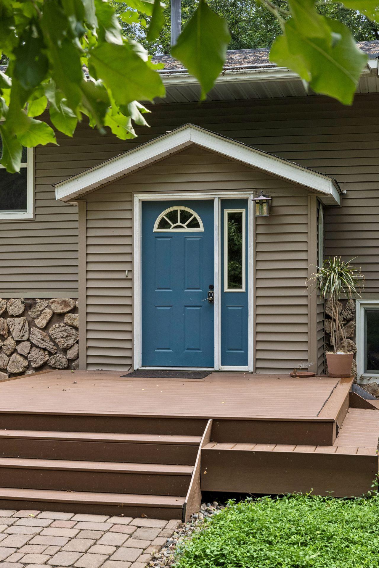 Welcoming front entry deck with space for a charming bistro set!