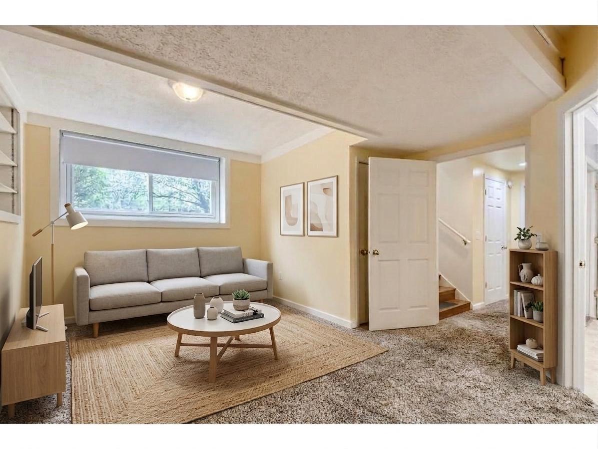 Spacious lower-level family room features a bright lookout window, cozy plush carpeting, and a versatile layout perfect for a media room or play area! *Virtually staged to show design options.