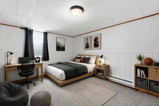 Virtually staged lower-level bedroom showcasing the spaceâs potential