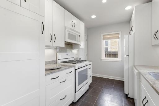Kitchen with gas range and convenient over-the-range microwave.