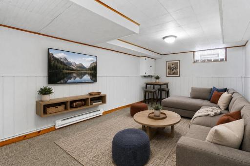 Virtually staged lower-level family room showcasing the spaceâs potential.