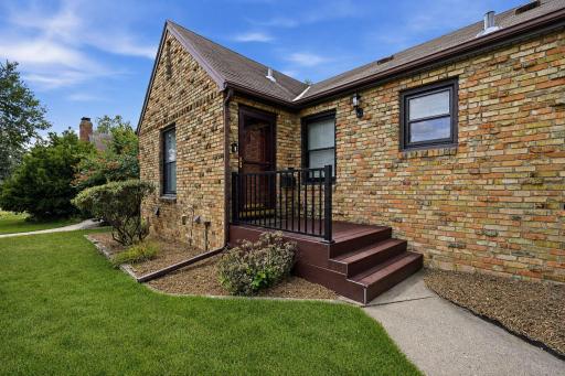 Inviting front entry surrounded by mature landscaping