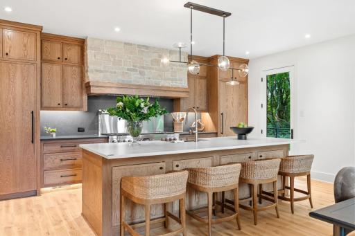 Step over to the Chef's kitchen with spacious center island, Cambria countertops, and solid White Oak cabinets