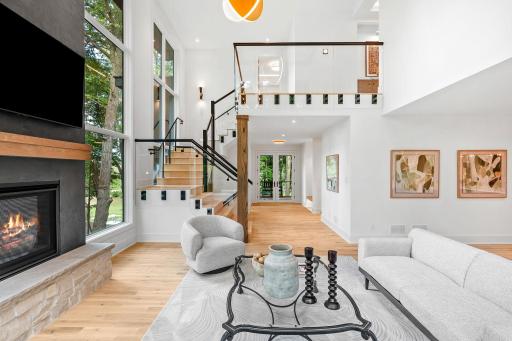 Breathtaking great room with walls of glass, natural light, and seamless flow to the upper level