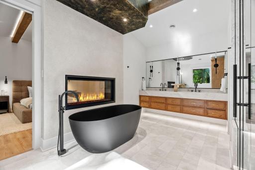 Luxurious primary full bathroom with ventian plaster and heated floors
