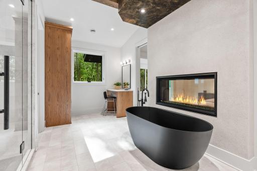 Large soaker tub with double sided fireplace