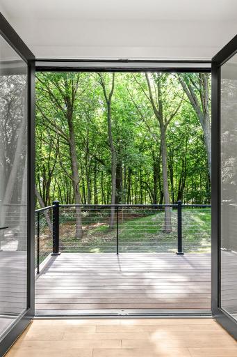 Private wooded views off the primary bedroom balcony
