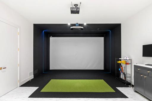 Fabulous entertainment room with a 17 foot media screen that could be a golf simulator, movie theater, or multi sport simulator.