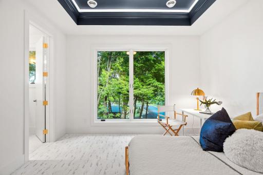 Third bedroom on the upper level with en-suite bath and wooded views