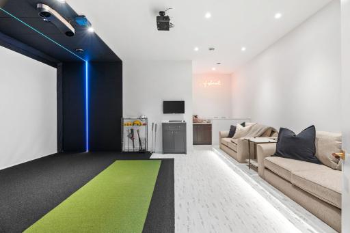 Fabulous entertainment room with a 17 foot media screen that could be a golf simulator, movie theater, or multi sport simulator.
