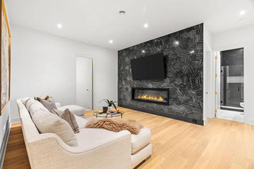 Lower level Rec Room with a floor to ceiling fabulous file wall and fireplace