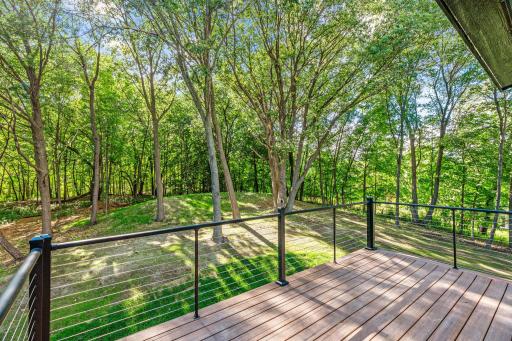 Private wooded views off the primary bedroom balcony