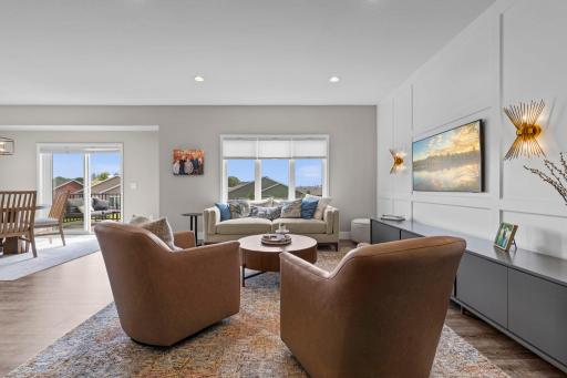 Stunning living room space features a striking board-and-batten wood accent wall, creating warmth and character throughout. Fabulous open-concept!