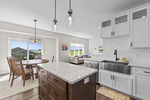 Gorgeous kitchen space! Beautifully white cabinetry, Quartz countertops, subway tiled backsplash, Stainless Steel appliances and farmhouse sink. Center island offers breakfast bar space and convenient drawer storage.