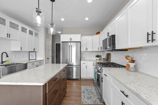 Gorgeous kitchen space! Beautifully white cabinetry, Quartz countertops, subway tiled backsplash, Stainless Steel appliances and farmhouse sink. Center island offers breakfast bar space and convenient drawer storage.