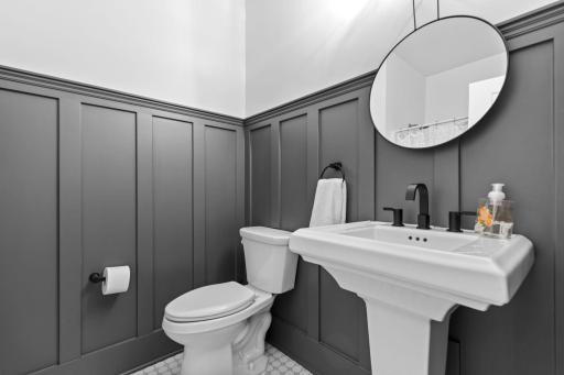 Main floor full bathroom showcases beautiful wall accents and stylish designer touches, creating an elegant and inviting space.