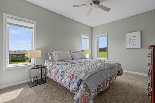 Primary suite with abundance of windows create a warm, light filled space.