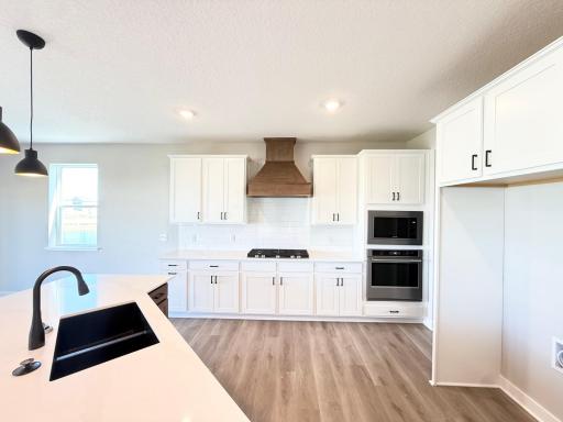 Photo from Actual Home: Large stained wood hood covers your 5 burner cooktop stove