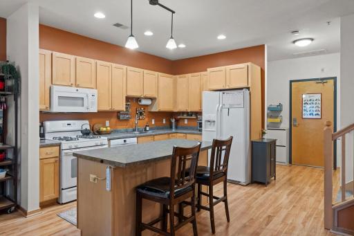 Large kitchen with center island and breakfast bar seating, featuring an ultra-quiet dishwasher and new garbage disposal.