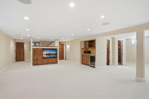 2200 Kenwood Parkway - Lower Level includes built-in entertainment area, a wet bar, fridge, and cabinetry