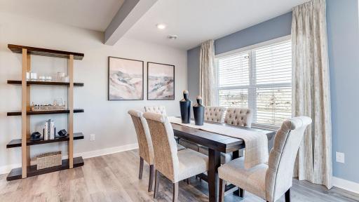 Spacious dining room with ample amounts of natural light adjacent to patio! (Model photo, colors may vary)