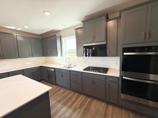 Photo From Actual Home: This signature kitchen features a large cooktop, Double ovens, and tons of storage.